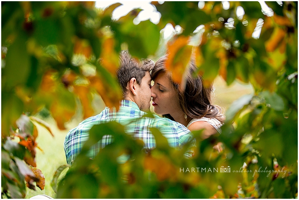 Liv and Sean Kissing Behind Leaves