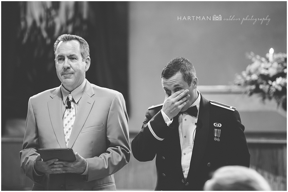 Groom Johnny tearing up in ceremony
