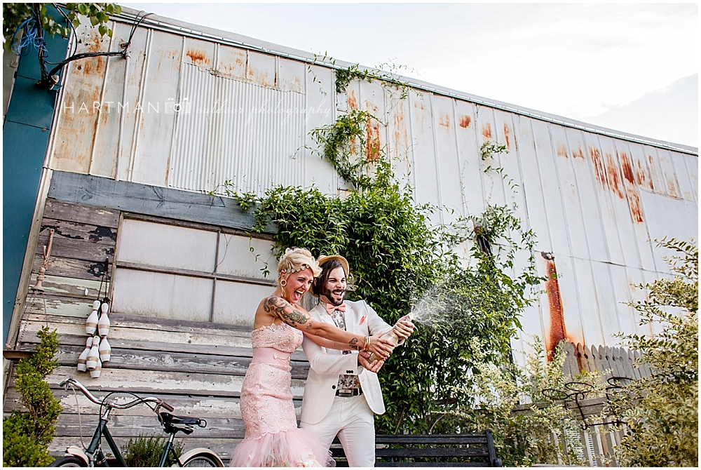 Newlyweds Popping Champagne Bottle